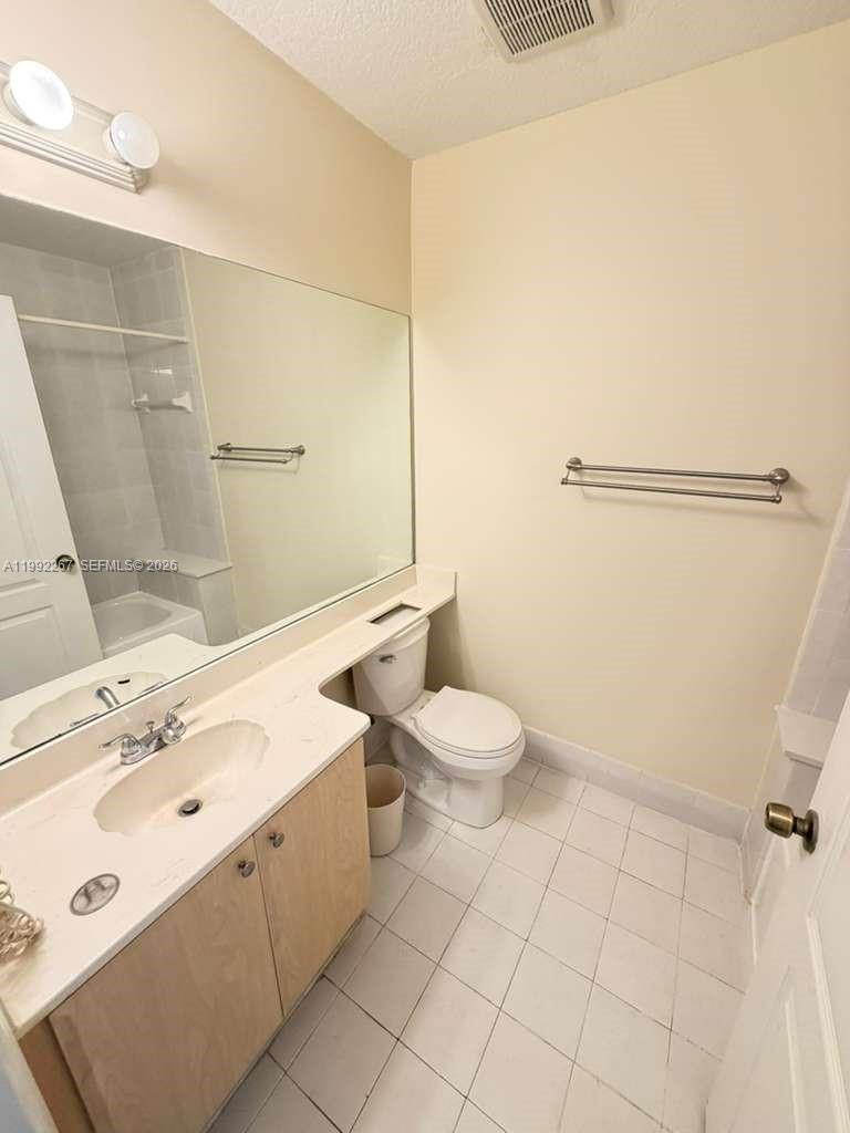 12625 Southwest 91st Street, Unit 209 Miami, FL 33186 - Photo 17 of 17 a bathroom with a sink mirror and toilet