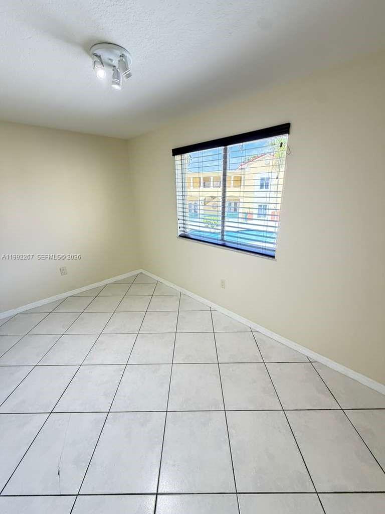12625 Southwest 91st Street, Unit 209 Miami, FL 33186 - Photo 4 of 17 a view of an empty room with a window