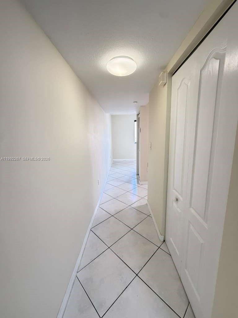 12625 Southwest 91st Street, Unit 209 Miami, FL 33186 - Photo 5 of 17 a view of a hallway