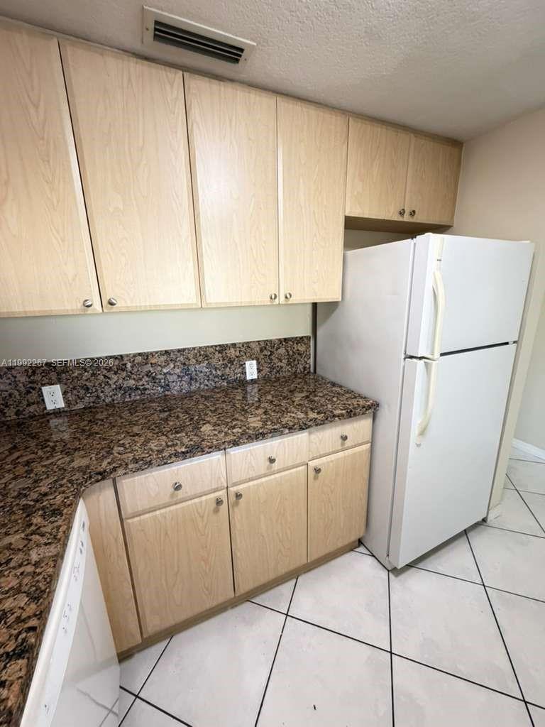 12625 Southwest 91st Street, Unit 209 Miami, FL 33186 - Photo 7 of 17 a white refrigerator freezer sitting inside of a kitchen