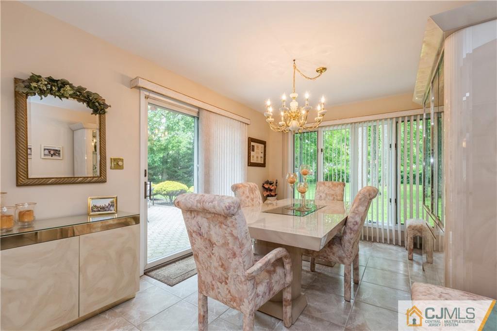 18 Frances Road Edison, NJ 08820 - Photo 13 of 29 a view of a dining room with furniture large windows and wooden floor