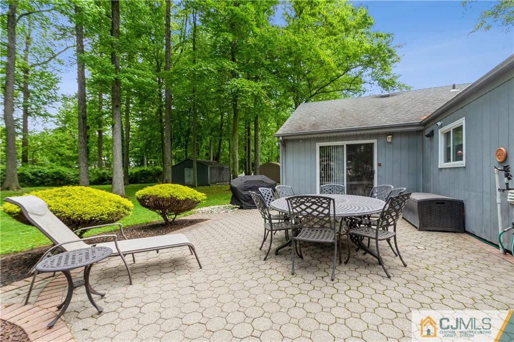18 Frances Road Edison, NJ 08820 - Photo 27 of 29 a view of a patio with table and chairs and potted plants