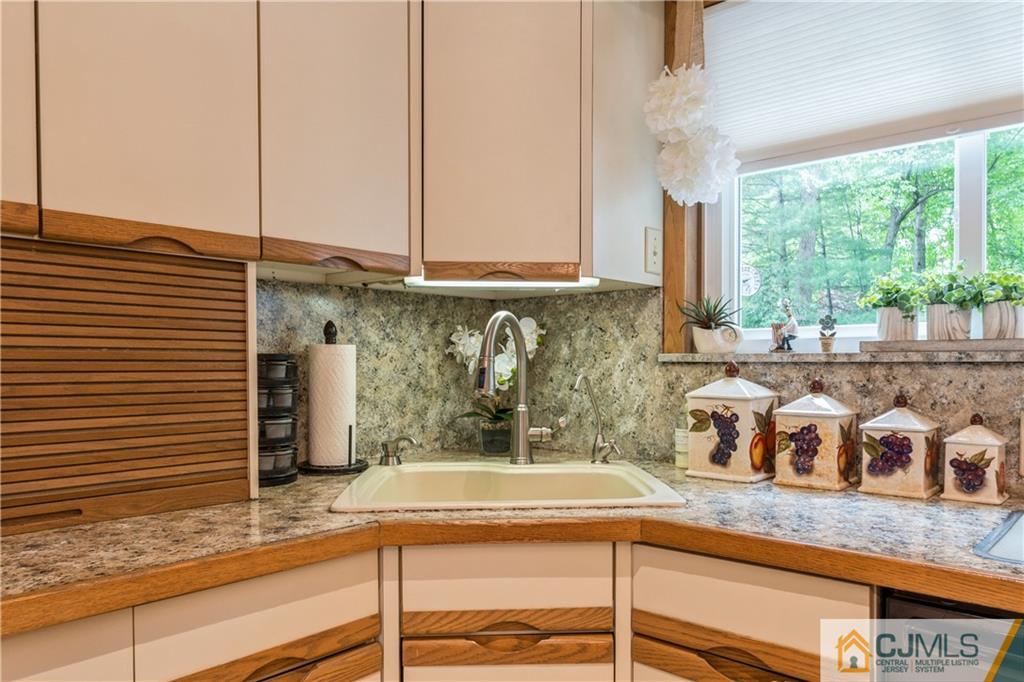 18 Frances Road Edison, NJ 08820 - Photo 9 of 29 a kitchen with kitchen island granite countertop a sink a granite counter tops and a large window