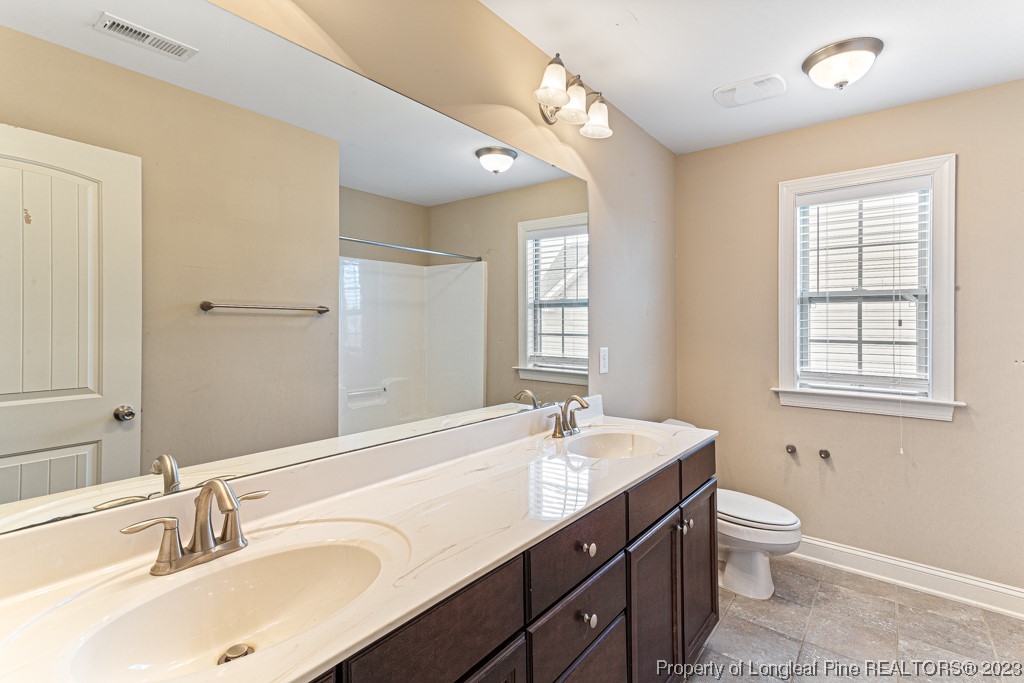 30 Appomattox Drive Cameron, NC 28326 - Photo 21 of 33 a bathroom with a sink double vanity and a bathtub