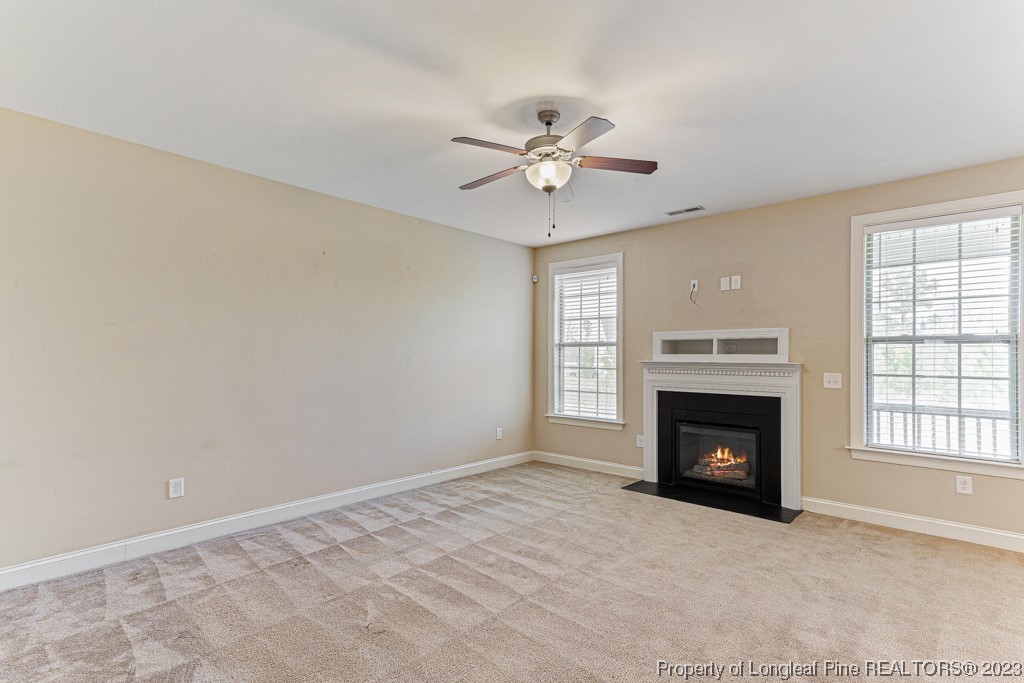 30 Appomattox Drive Cameron, NC 28326 - Photo 7 of 33 an empty room with windows and fireplace