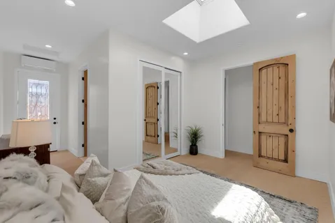 a bedroom with a bed and a potted plant