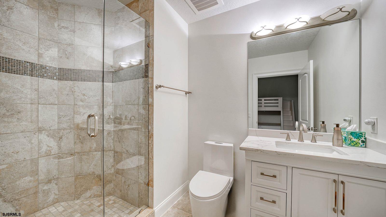 611 Riviera Dunes Way, Unit 702 Palmetto, FL 34221 - Photo 28 of 54 a bathroom with a shower sink vanity mirror and toilet