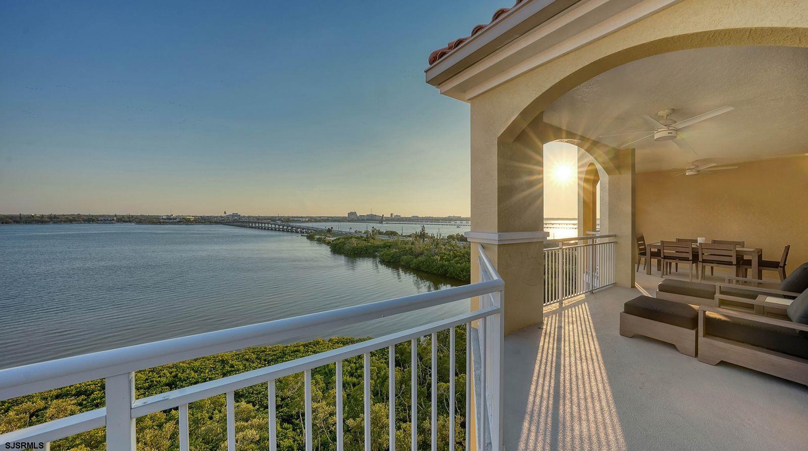 611 Riviera Dunes Way, Unit 702 Palmetto, FL 34221 - Photo 32 of 54 a view of a balcony with couches and wooden floor