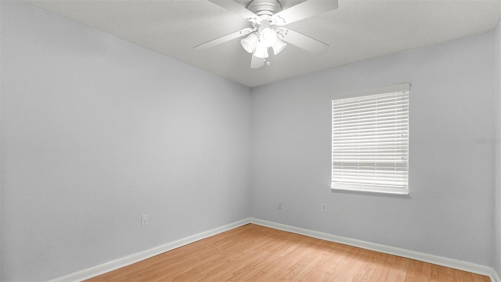 501 Southwest 75th Street, Unit B5 Gainesville, FL 32607 - Photo 25 of 38 wooden floor in an empty room with a window