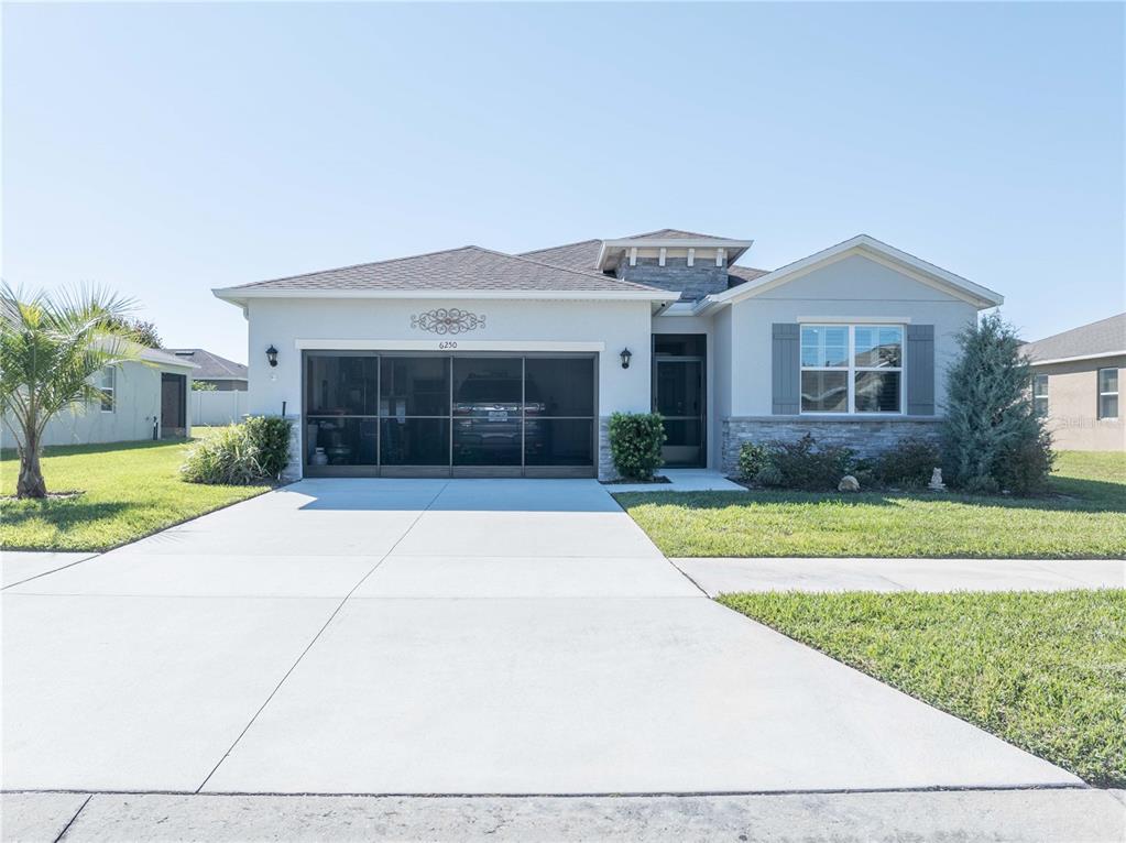a front view of house with yard and green space
