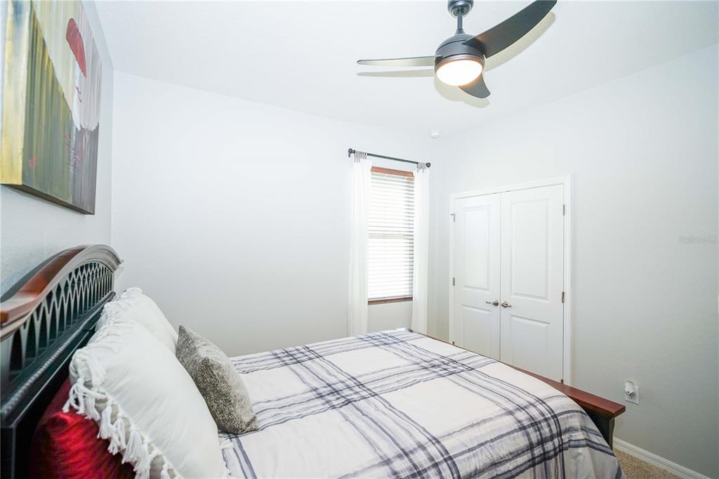 6250 Southwest 89th Ln Road Ocala, FL 34476 - Photo 17 of 71 a bedroom with a bed and a chandelier