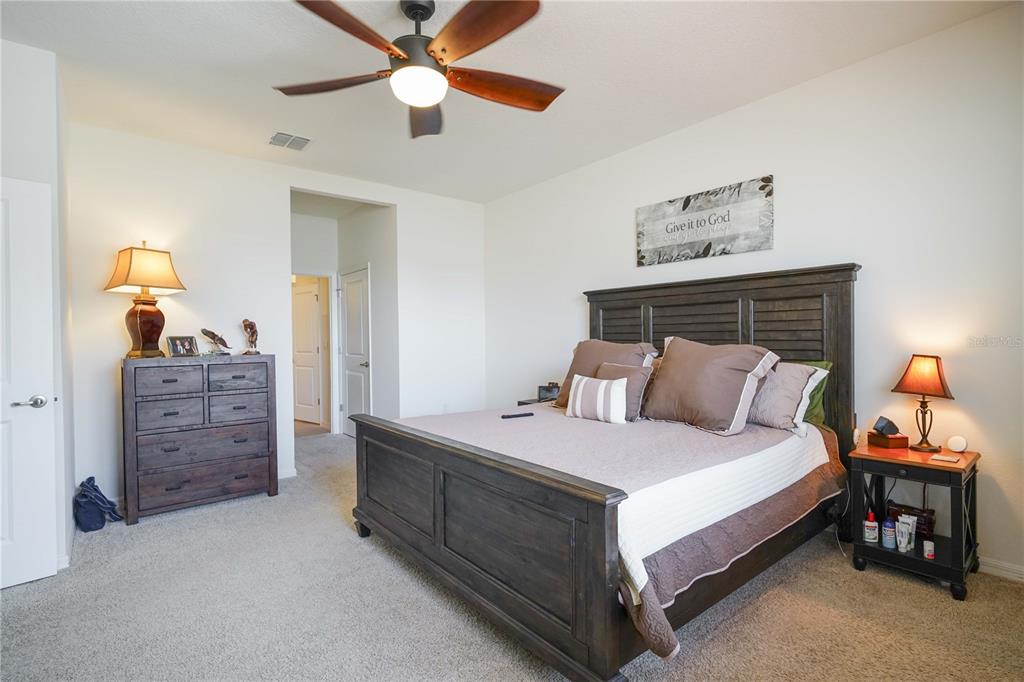 6250 Southwest 89th Ln Road Ocala, FL 34476 - Photo 22 of 71 a bedroom with a bed and a chandelier