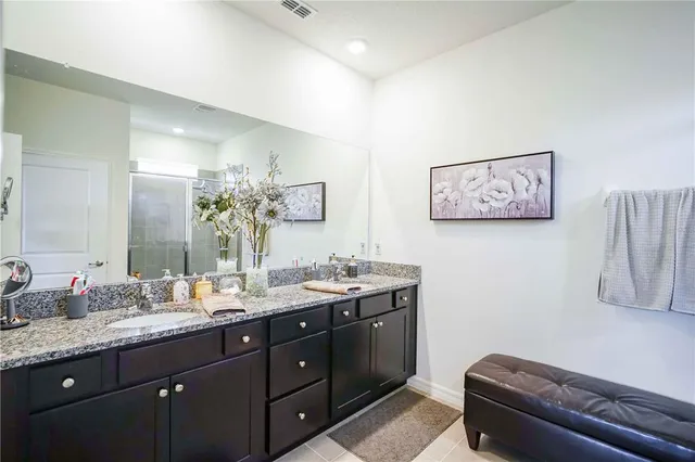 a kitchen with stainless steel appliances granite countertop a refrigerator a stove and a sink with wooden floor