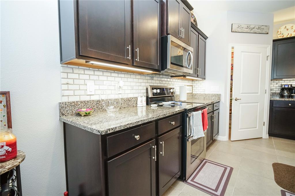 6250 Southwest 89th Ln Road Ocala, FL 34476 - Photo 35 of 71 a kitchen with stainless steel appliances granite countertop a sink stove and refrigerator