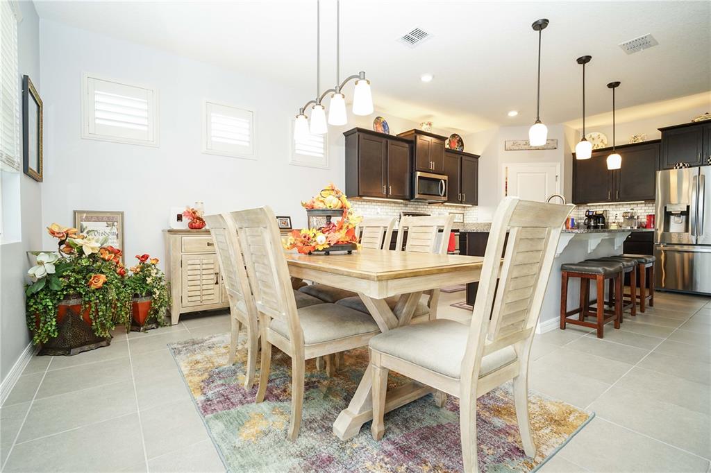 6250 Southwest 89th Ln Road Ocala, FL 34476 - Photo 38 of 71 a dining room with furniture and a flat screen tv
