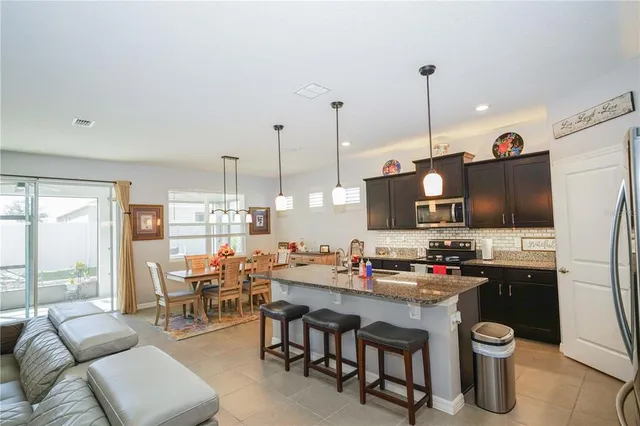a view of a porch with furniture and a yard