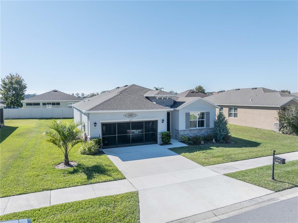6250 Southwest 89th Ln Road Ocala, FL 34476 - Photo 5 of 71 a front view of a house with garden