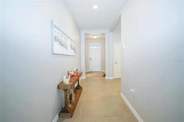a bedroom with a bed and a flat tv screen on a dresser
