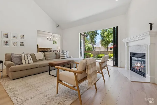 a living room with furniture a fireplace and a flat screen tv