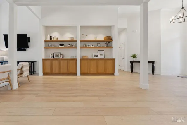 a patio with a table and chairs and potted plants
