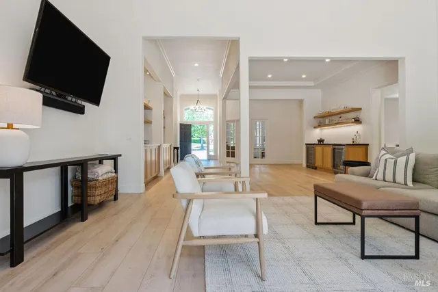 a spacious bathroom with double vanity a mirror and a shower