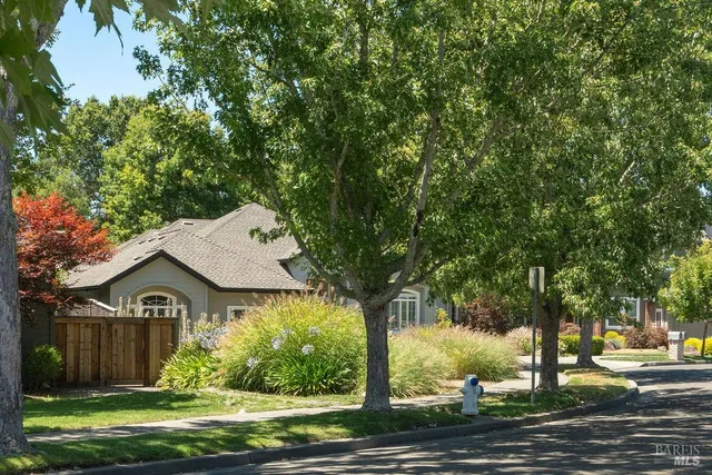 a front view of house with yard and green space