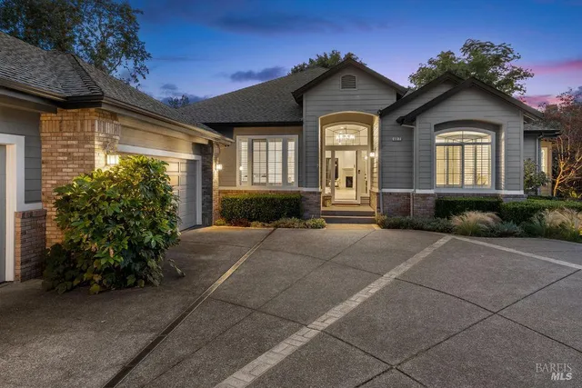 a view of a patio with a table and chairs under an umbrella