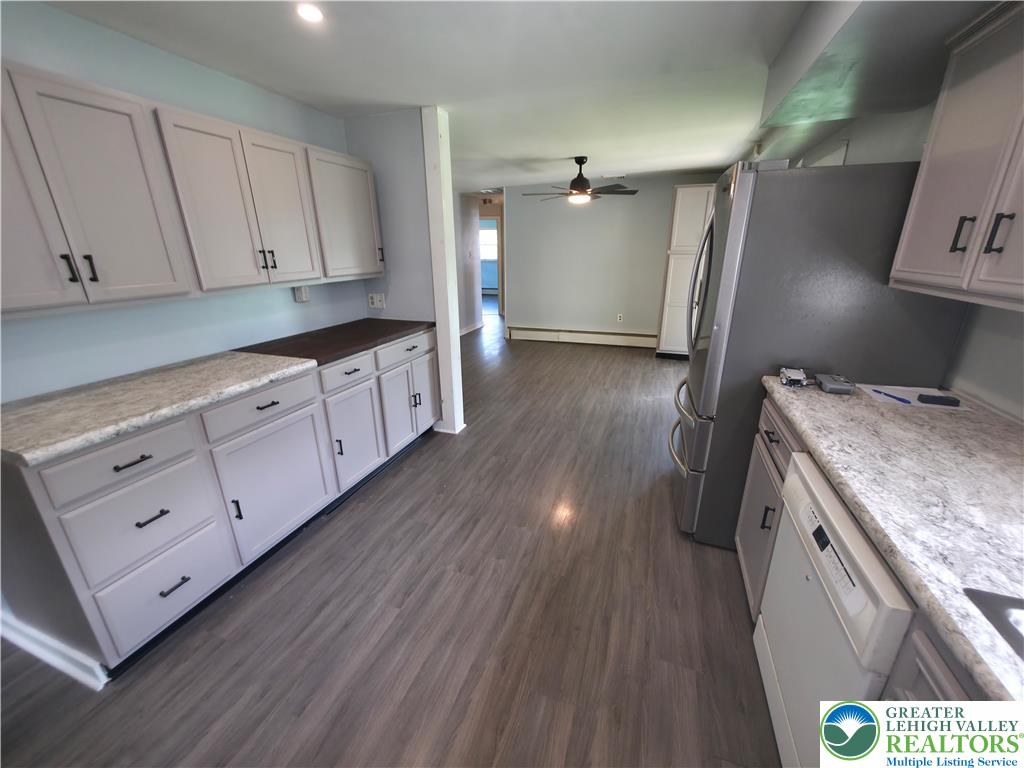 719 Keystone Avenue Bethlehem, PA 18018 - Photo 13 of 32 Functional kitchen offers ample cabinetry and counter space, with durable laminate flooring throughout.