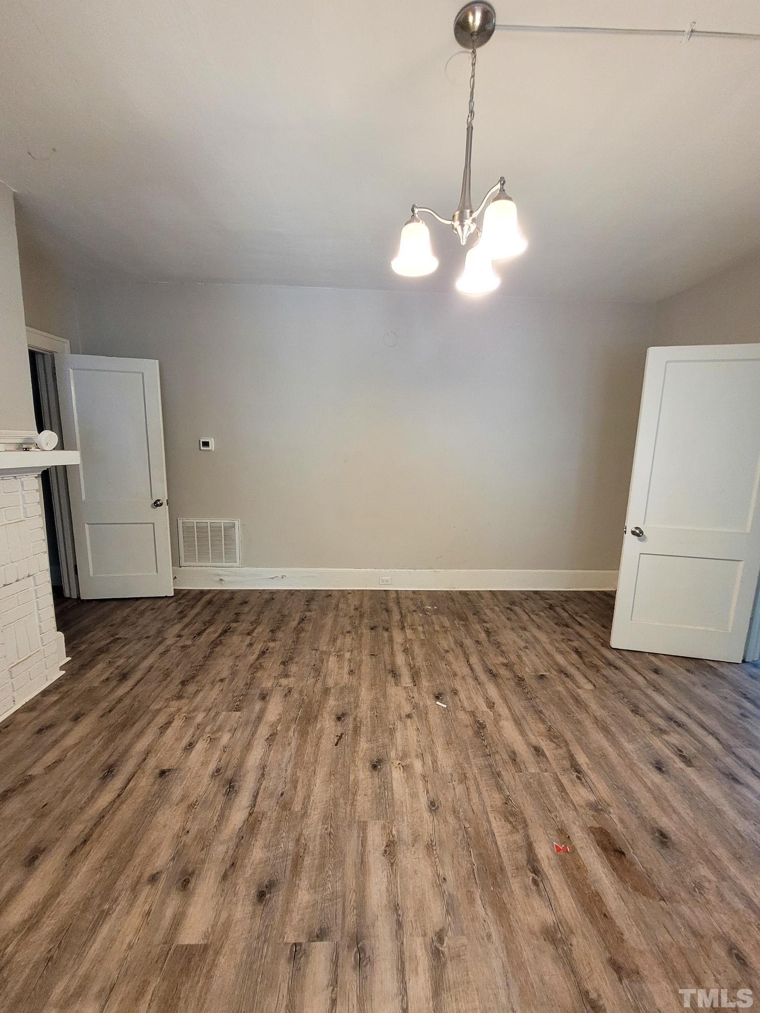 802 Park Avenue, Unit B Durham, NC 27703 - Photo 11 of 23 a view of a room with wooden floor and white walls