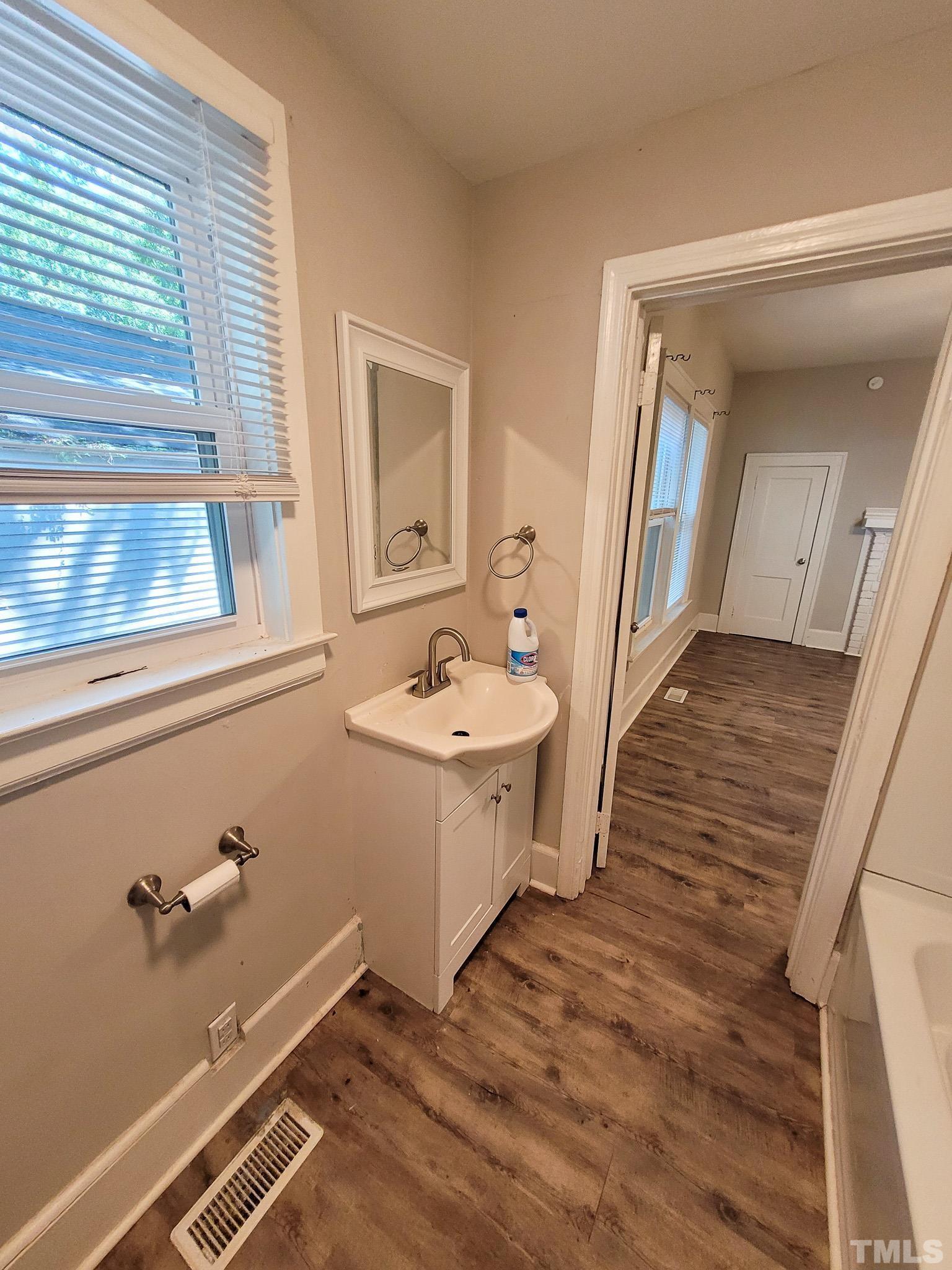 802 Park Avenue, Unit B Durham, NC 27703 - Photo 15 of 23 a bathroom with a sink a mirror and a bathtub