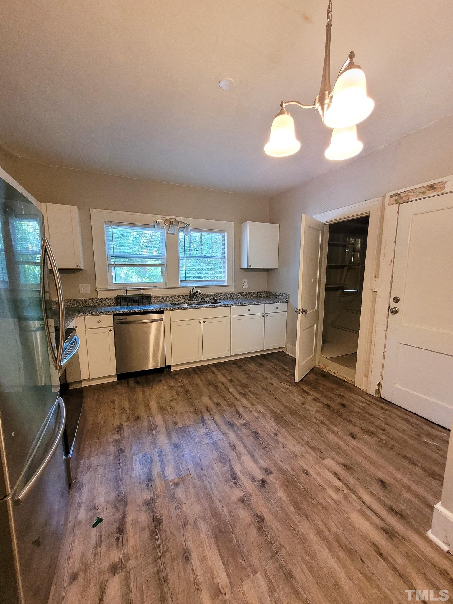 802 Park Avenue, Unit B Durham, NC 27703 - Photo 17 of 23 a view of a kitchen with a sink dishwasher cabinets and wooden floor