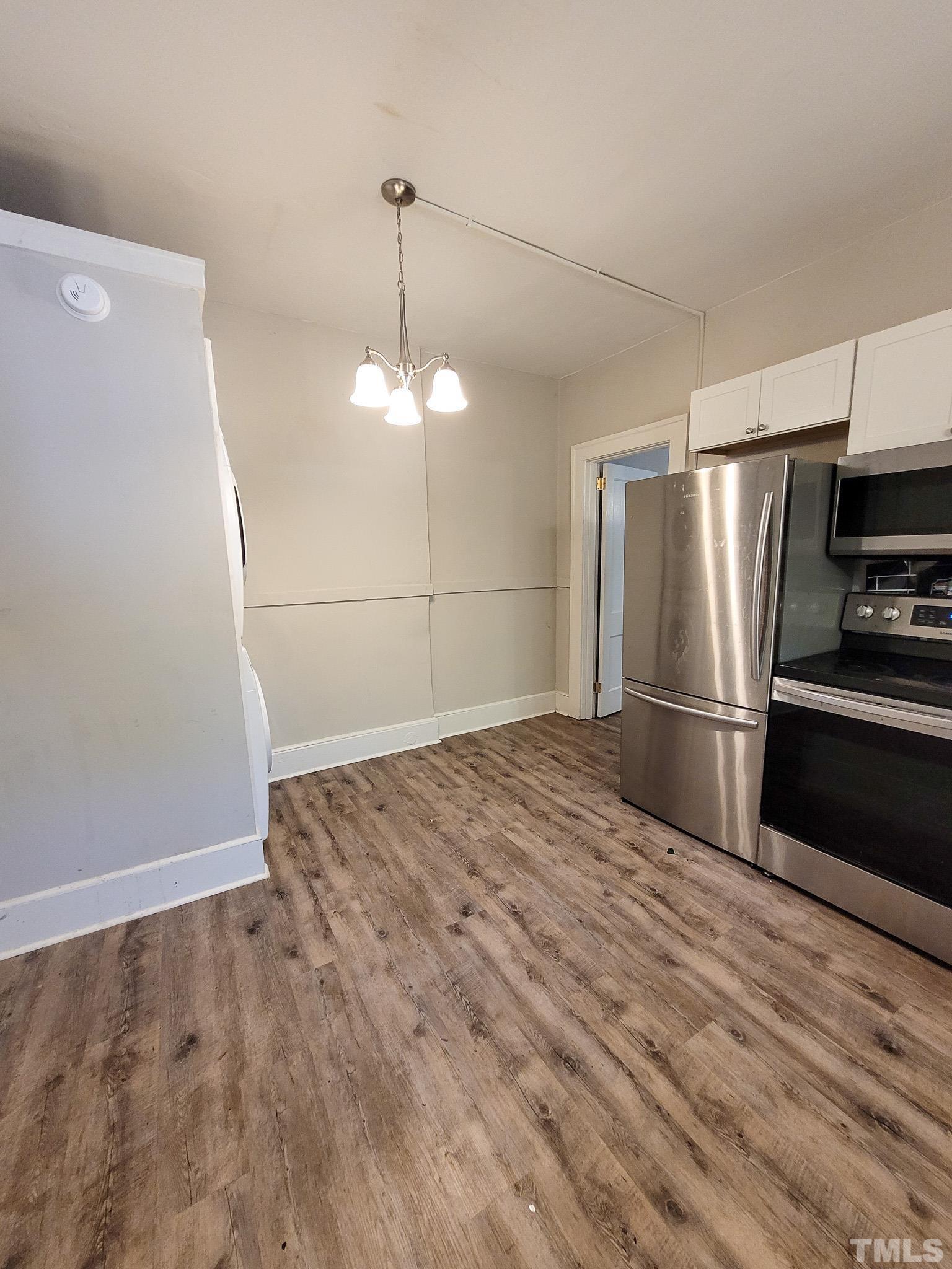 802 Park Avenue, Unit B Durham, NC 27703 - Photo 20 of 23 a view of a kitchen with a stove and refrigerator