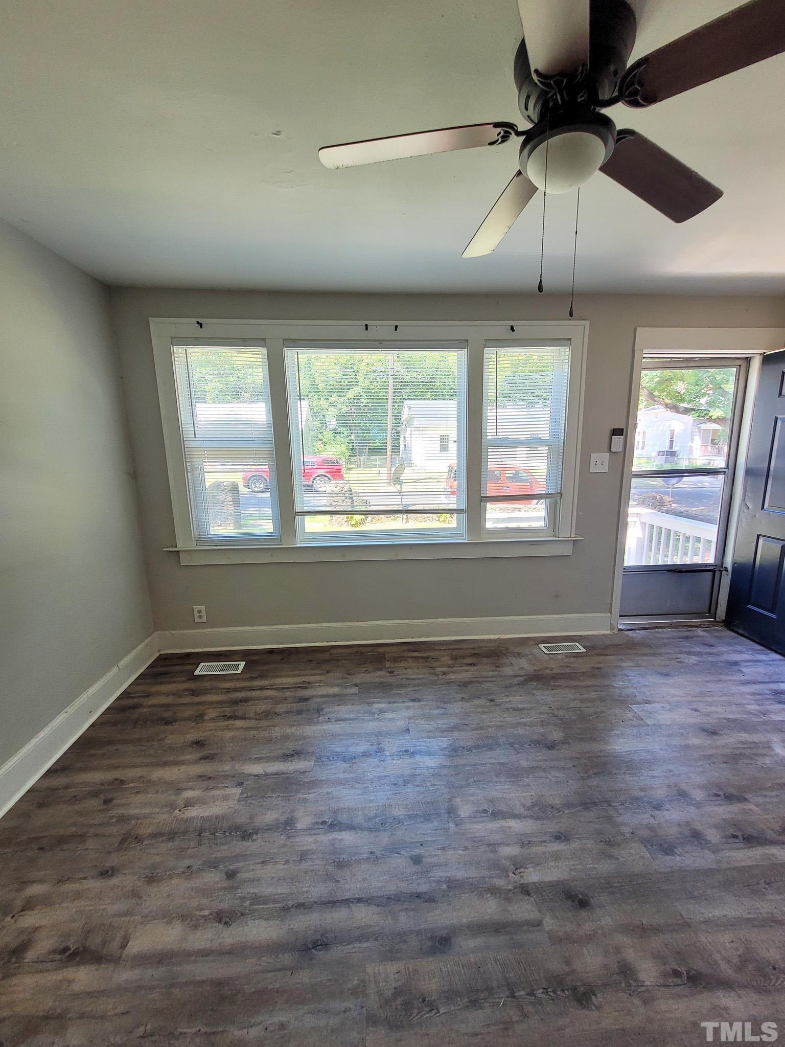 802 Park Avenue, Unit B Durham, NC 27703 - Photo 6 of 23 a view of an empty room with window and chandelier fan