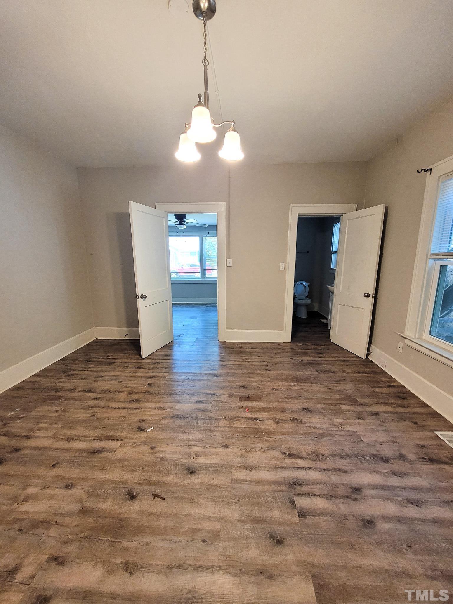 802 Park Avenue, Unit B Durham, NC 27703 - Photo 10 of 23 a view of an empty room with window and wooden floor