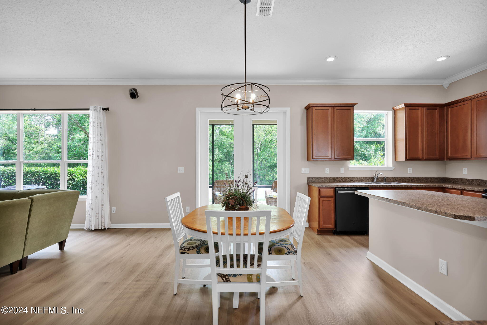 137 Castlegate Lane St. Johns, FL 32259 - Photo 13 of 65 a kitchen with stainless steel appliances granite countertop wooden floor dining table and chairs