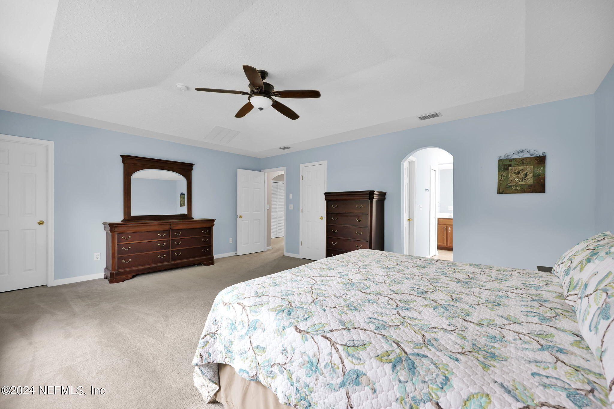 137 Castlegate Lane St. Johns, FL 32259 - Photo 30 of 65 a bedroom with a bed and a chandelier