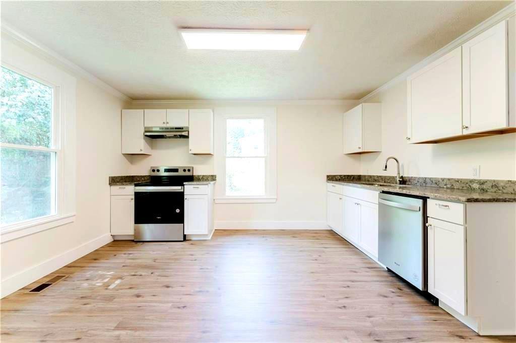 430 East 3rd Street Rome, GA 30161 - Photo 11 of 23 a kitchen with granite countertop a stove top oven and sink