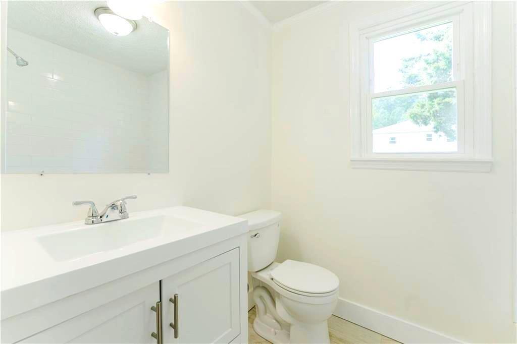 430 East 3rd Street Rome, GA 30161 - Photo 13 of 23 a bathroom with a sink a toilet and a mirror