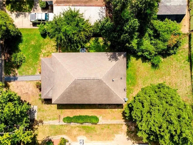 an aerial view of a house with a yard and garden