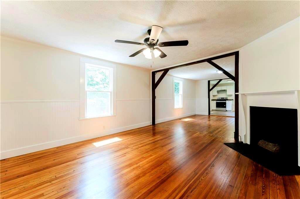 430 East 3rd Street Rome, GA 30161 - Photo 6 of 23 a view of a livingroom with wooden floor a ceiling fan and windows