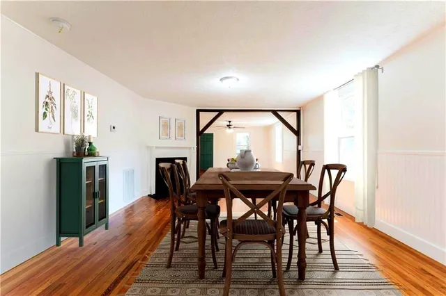 a view of a dining room with furniture and wooden floor