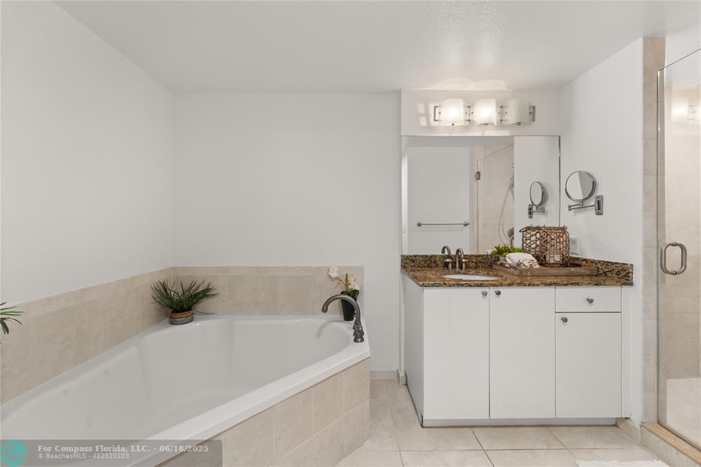 1830 Radius Drive, Unit 605 Hollywood, FL 33020 - Photo 12 of 38 a bathroom with a bathtub and a sink