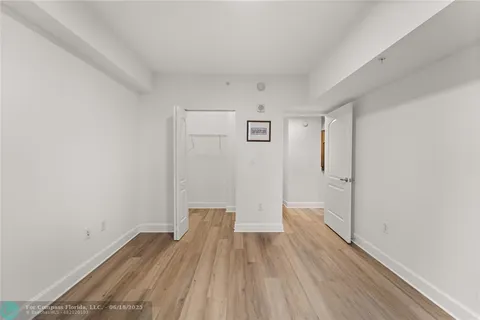 a view of a room with a painting on the wall