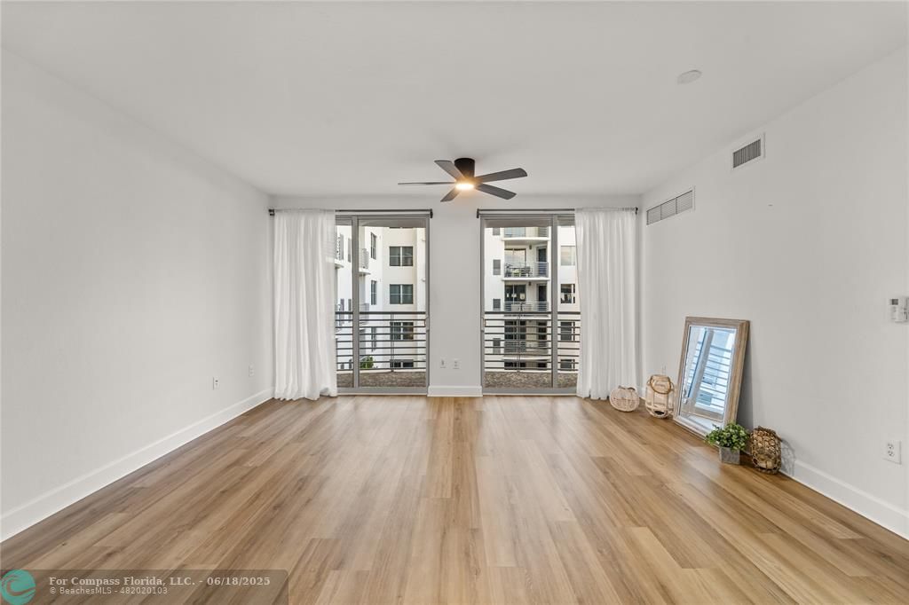 1830 Radius Drive, Unit 605 Hollywood, FL 33020 - Photo 3 of 38 a view of an empty room with a window and wooden floor