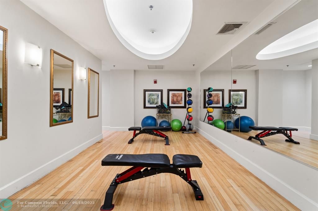 1830 Radius Drive, Unit 605 Hollywood, FL 33020 - Photo 32 of 38 a bedroom with furniture and a wooden floor