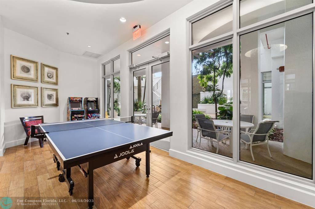 1830 Radius Drive, Unit 605 Hollywood, FL 33020 - Photo 37 of 38 a room with furniture pool table and glass door