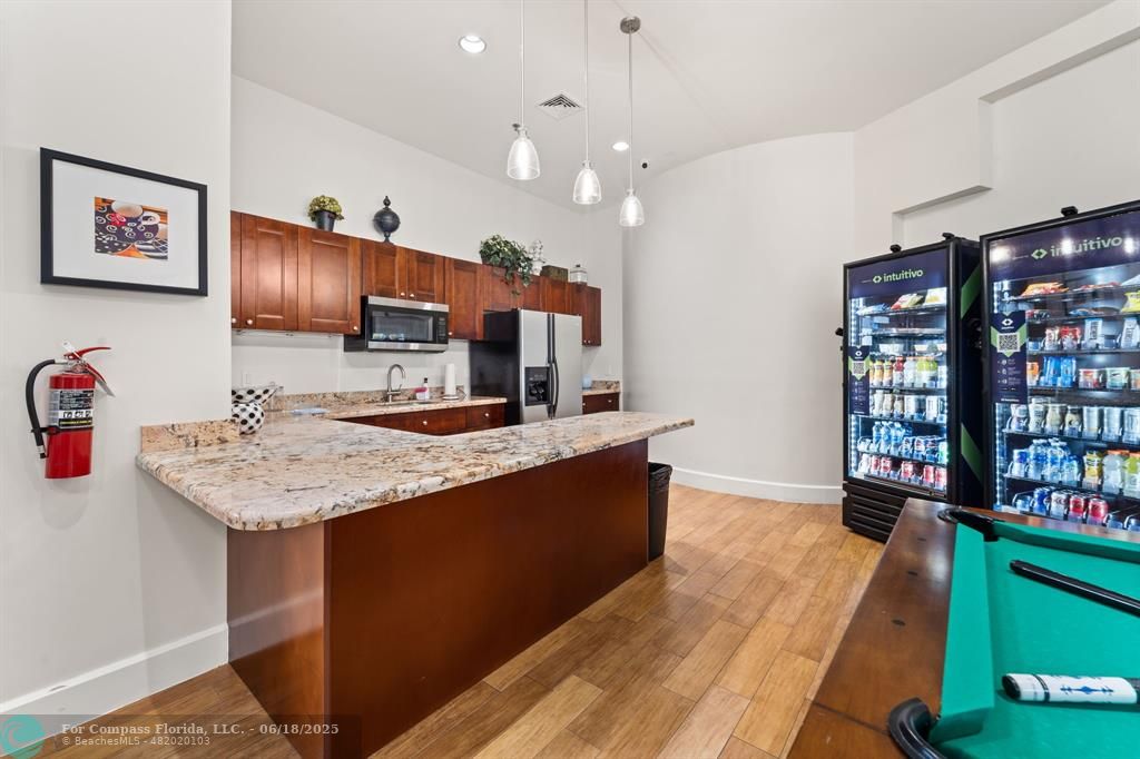 1830 Radius Drive, Unit 605 Hollywood, FL 33020 - Photo 38 of 38 a room with kitchen island stainless steel appliances lots of counter top space