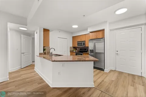 a kitchen with granite countertop cabinets washer and dryer