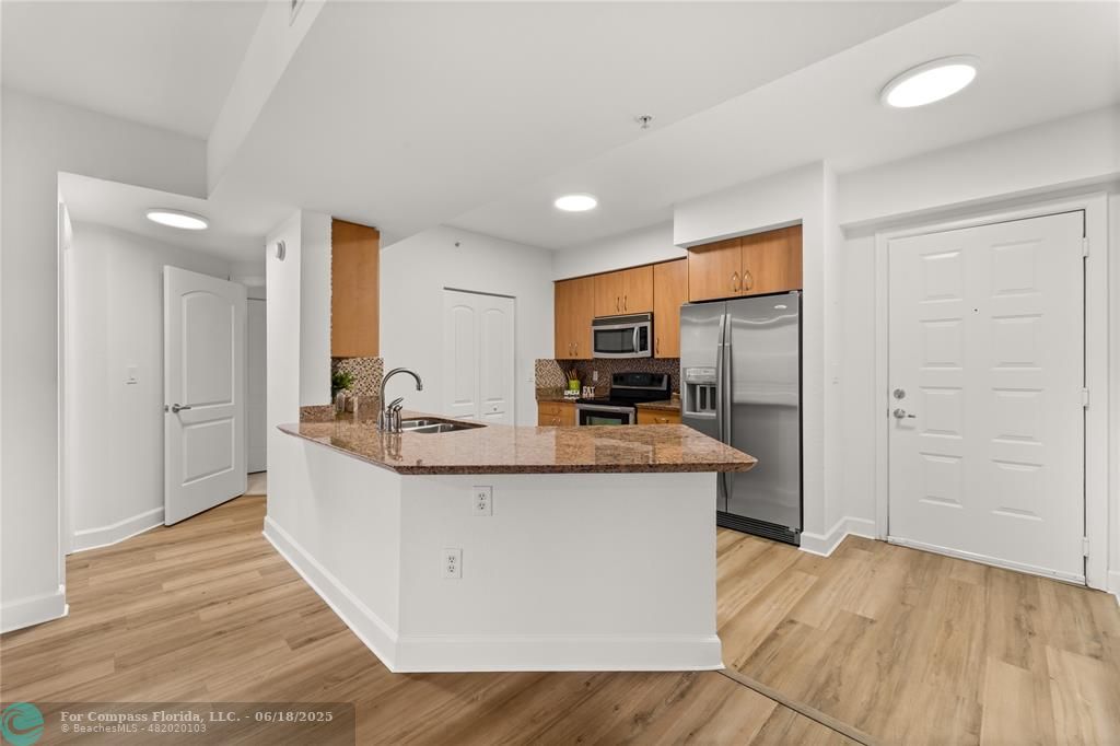 1830 Radius Drive, Unit 605 Hollywood, FL 33020 - Photo 5 of 38 a kitchen with stainless steel appliances a sink stove and refrigerator