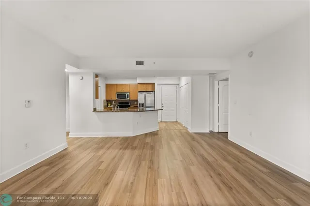 a view of living room and wooden floor